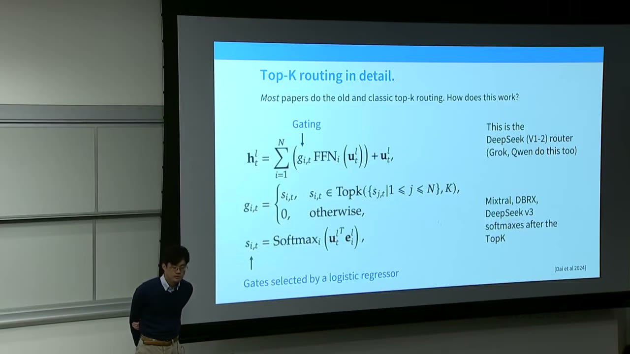 Speaker presenting a slide on Top-K routing in detail, showing gating and softmax functions.